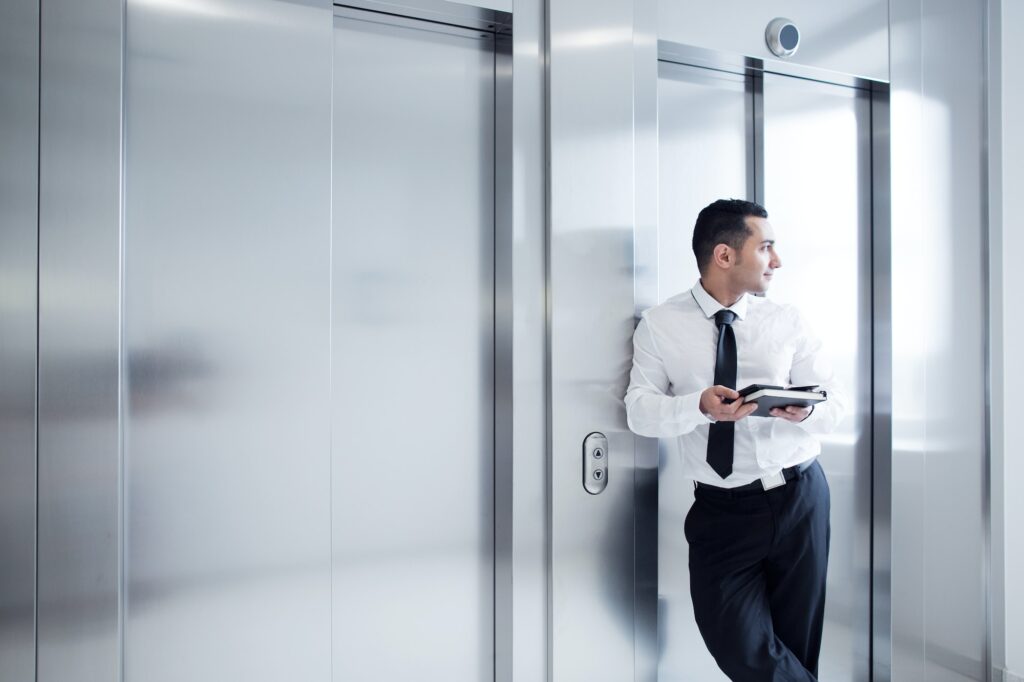 Business man leaning on elevator